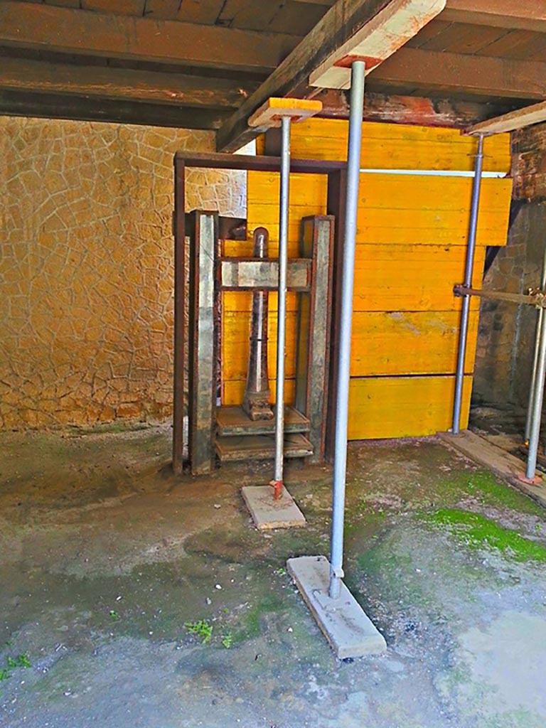 III.10, Herculaneum, photo taken between October 2014 and November 2019. 
Looking south across shop towards wooden screw press. Photo courtesy of Giuseppe Ciaramella.